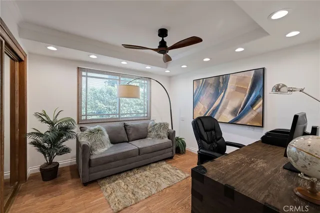 wooden floor with a view of a bathroom