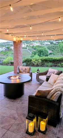 a view of a patio with couches chairs and a big yard