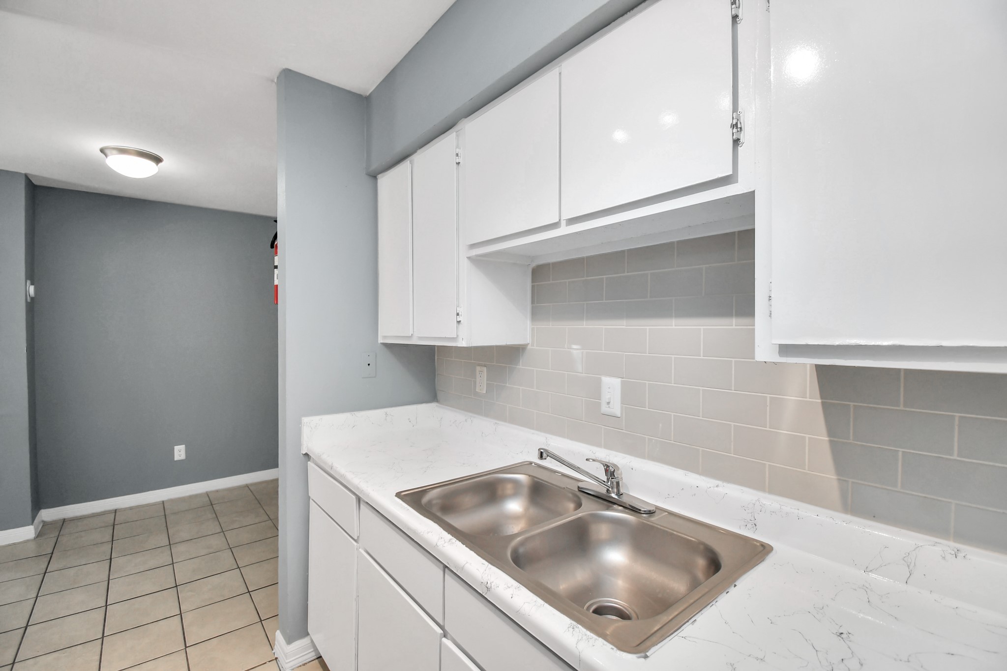 5959 Bonhomme Road, Unit 192R Houston, TX 77036 - Photo 20 of 26 a kitchen with a sink cabinets and utility