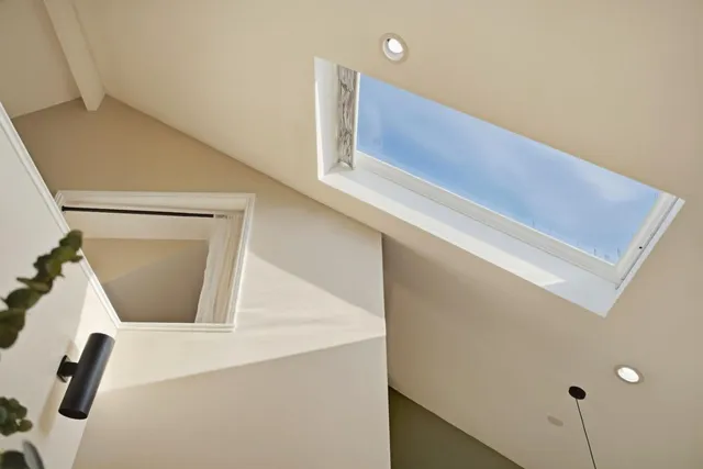 a view of kitchen with granite countertop cabinets and entryway