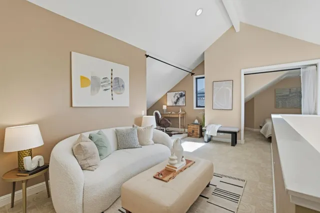 a living room with furniture and a potted plant