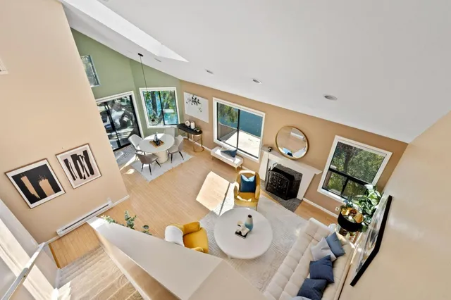 a living room with furniture a large window and a fireplace