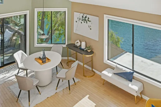 a dining room with furniture a chandelier and glass door