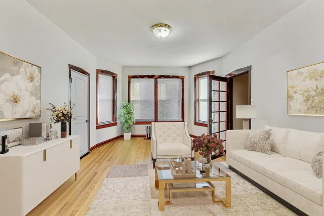 a kitchen with cabinets appliances and wooden floor