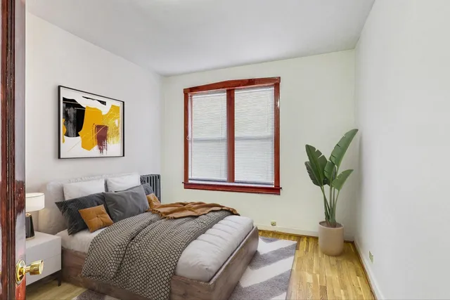 a bedroom with bed and window