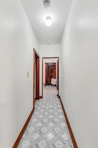a hallway with sliding door and yard in the background
