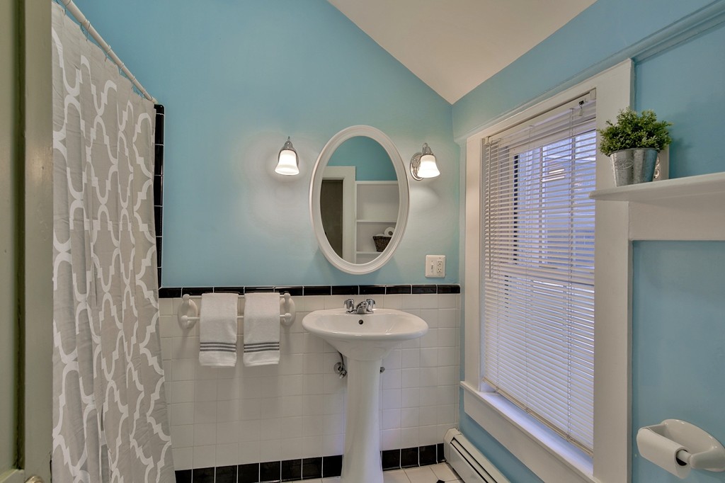 68 County Road, Unit C Ipswich, MA 01938 - Photo 11 of 13 a bathroom with a sink a mirror and a shower