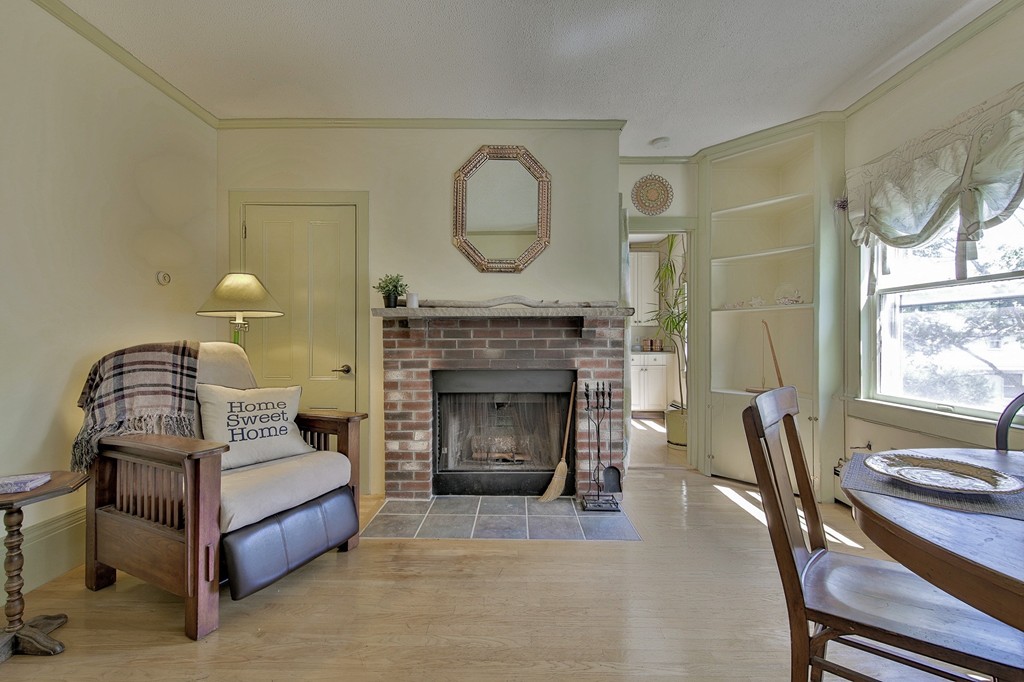 68 County Road, Unit C Ipswich, MA 01938 - Photo 3 of 13 a bedroom with a bed a fireplace and a large window
