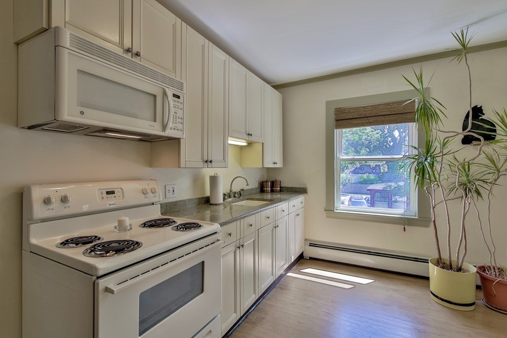 68 County Road, Unit C Ipswich, MA 01938 - Photo 5 of 13 a kitchen with stainless steel appliances a stove a microwave and a hard wood floors