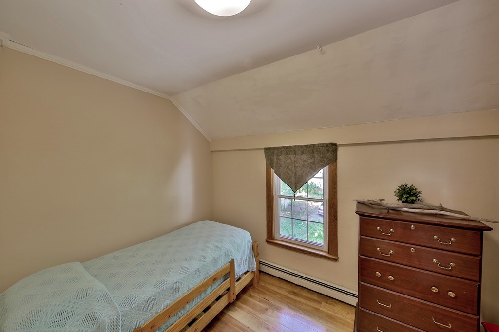 68 County Road, Unit C Ipswich, MA 01938 - Photo 7 of 13 a bedroom with a bed and a window