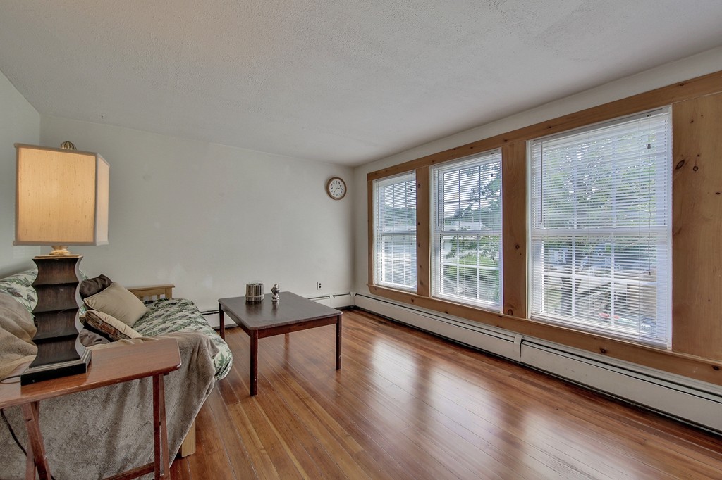 68 County Road, Unit C Ipswich, MA 01938 - Photo 9 of 13 a living room with furniture and a large window