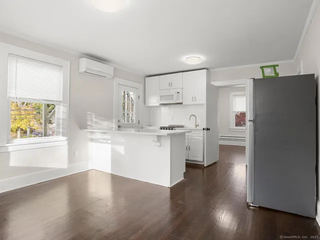 a kitchen with a refrigerator sink and cabinets