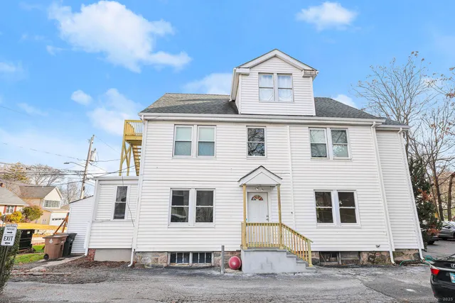 a front view of a house with a road