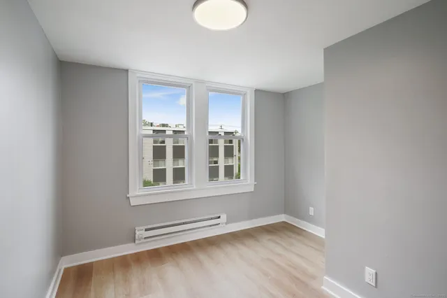 a view of a room with wooden floor