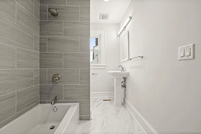 a bathroom with a bathtub and a shower