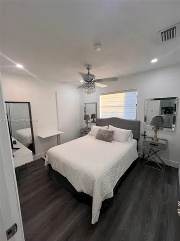 a bed room with a bed and a chair