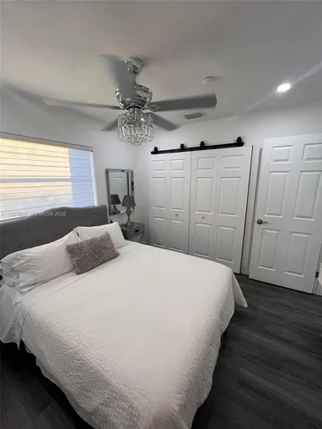 a bedroom with a bed and a mirror