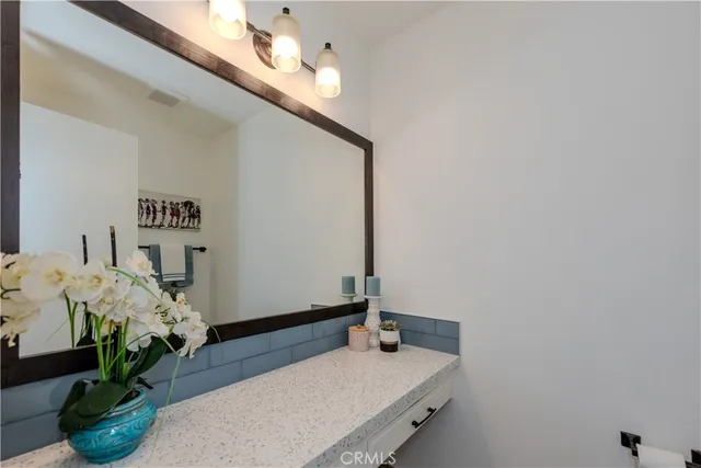 a room with painting on the wall and a table