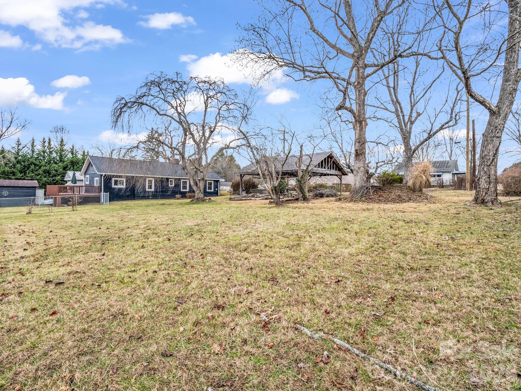 a view of a yard with a house in the background