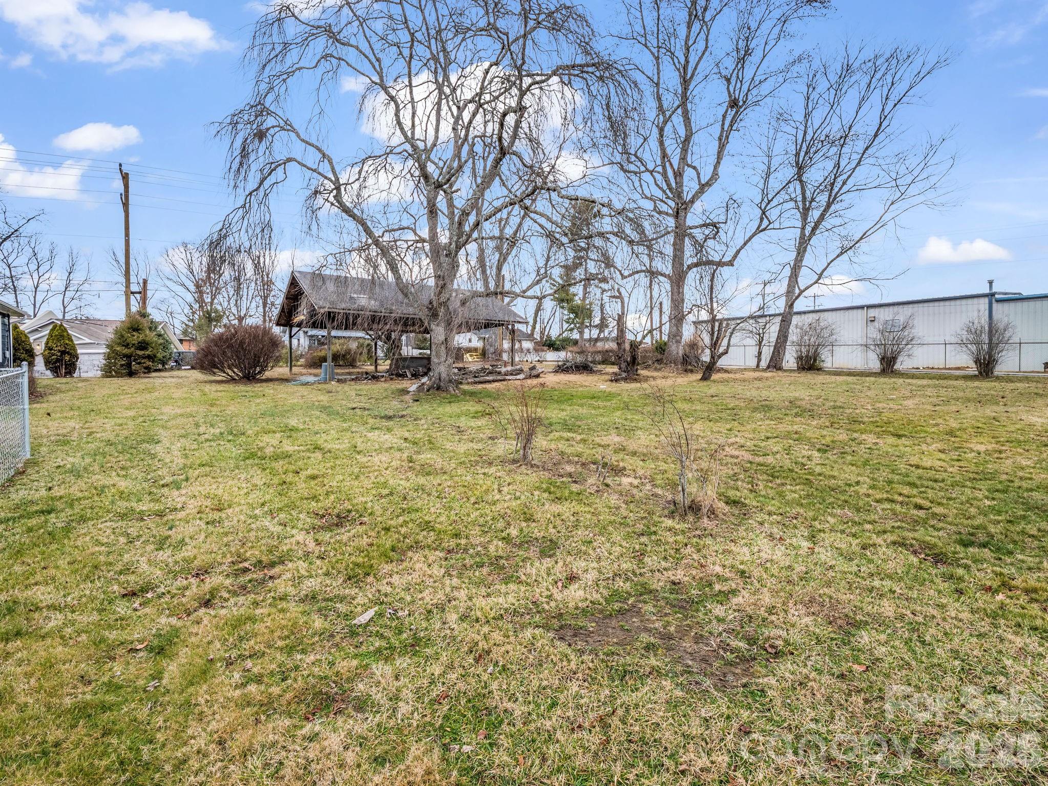 0 Ray Avenue Hendersonville, NC 28792 - Photo 4 of 18 a view of a yard with yellow house