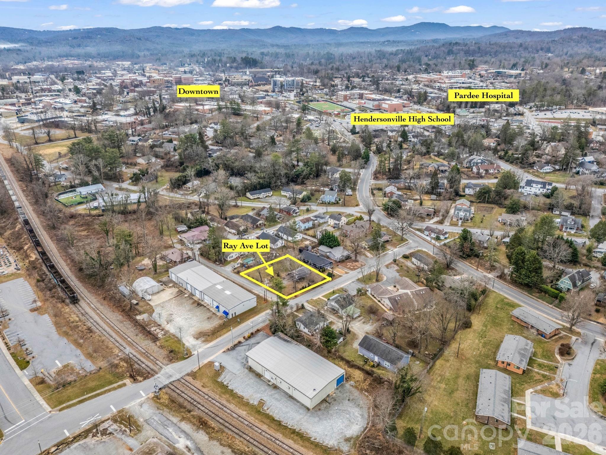 0 Ray Avenue Hendersonville, NC 28792 - Photo 5 of 18 an aerial view of a swimming pool with a yard and mountain view in back