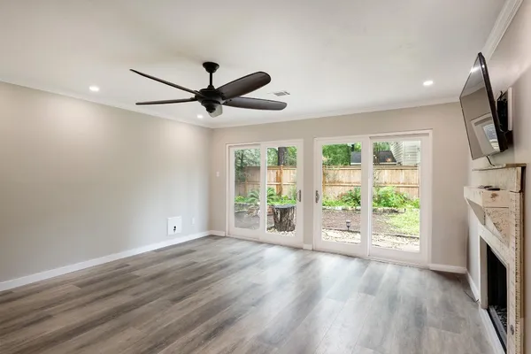 a kitchen with stainless steel appliances a sink a stove a refrigerator cabinets and a window