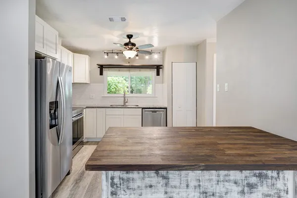 a bedroom with a large bed and a chandelier