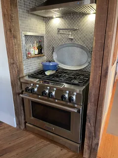 a stove top oven sitting inside of a kitchen