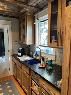 a kitchen with sink a window and cabinets