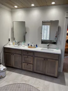 a bathroom with double vanity sink and a mirror