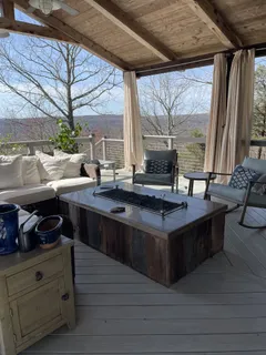 a living room with stainless steel appliances granite countertop furniture and a fireplace