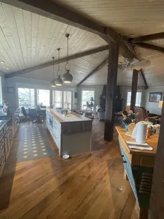 a large kitchen with a large counter top appliances and a window
