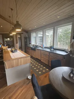 a kitchen with stainless steel appliances granite countertop a sink a stove and a wooden floors