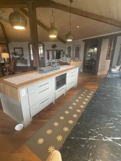 a large kitchen with kitchen island a sink stainless steel appliances and a counter top space
