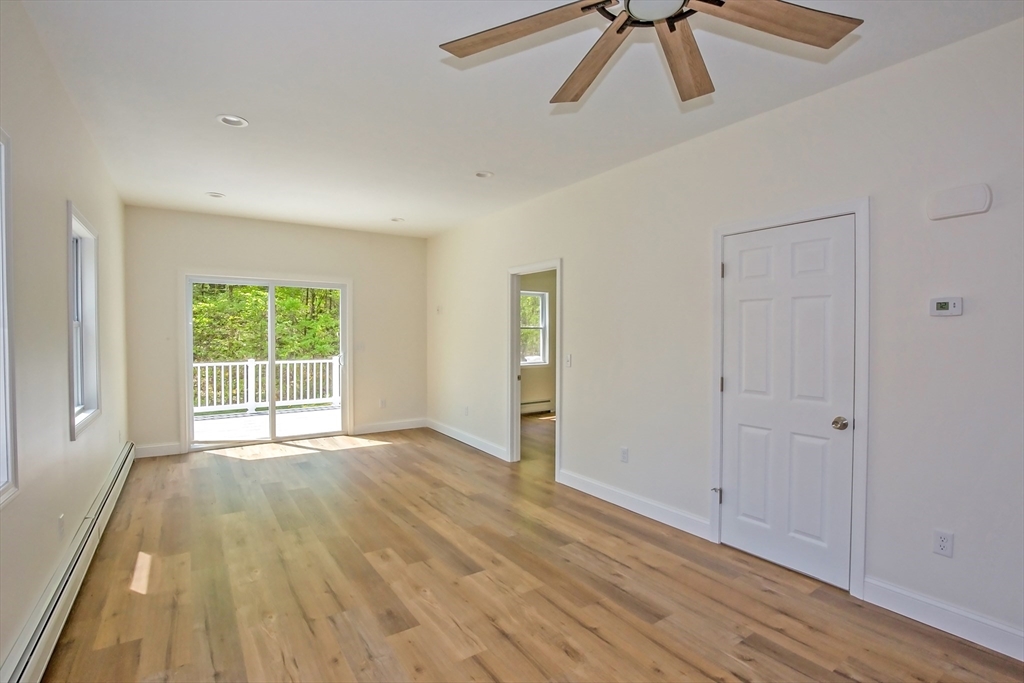 165 Sandisfield Road Sandisfield, MA 01255 - Photo 14 of 37 a view of an empty room with wooden floor and a window