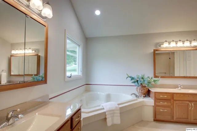 a bathroom with a bathtub a sink and a window