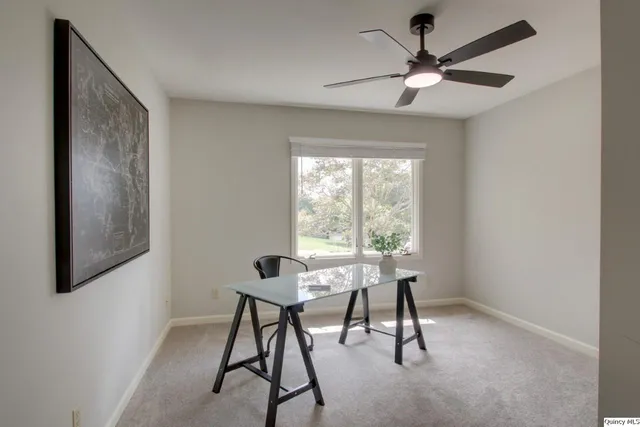 a workspace room with furniture and windows