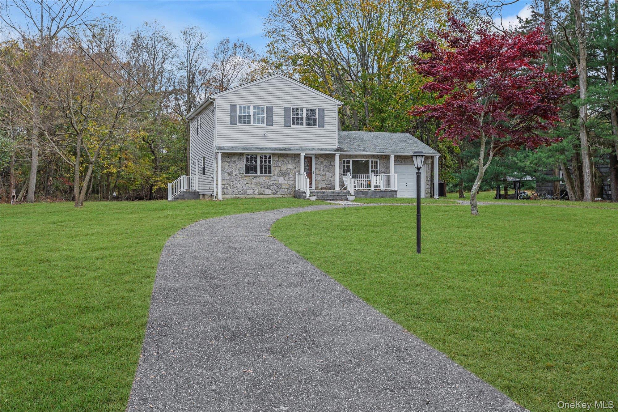 8 Mill Lot Road Middle Island, NY 11953 - Photo 2 of 20 a front view of a house with a yard