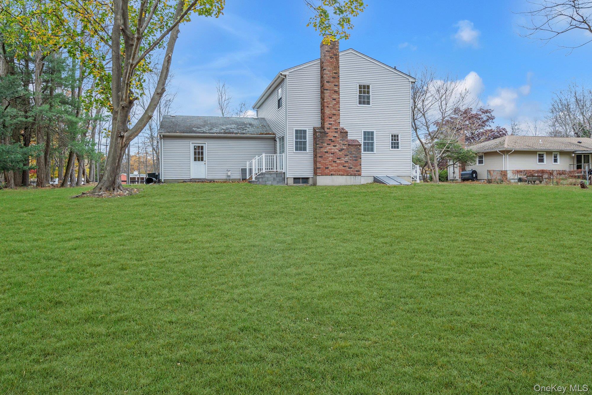 8 Mill Lot Road Middle Island, NY 11953 - Photo 4 of 20 a view of a back yard of the house