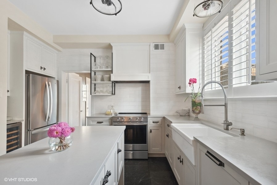 222 East Chestnut Street, Unit 17B Chicago, IL 60611 - Photo 11 of 29 a kitchen with a sink stove and cabinets