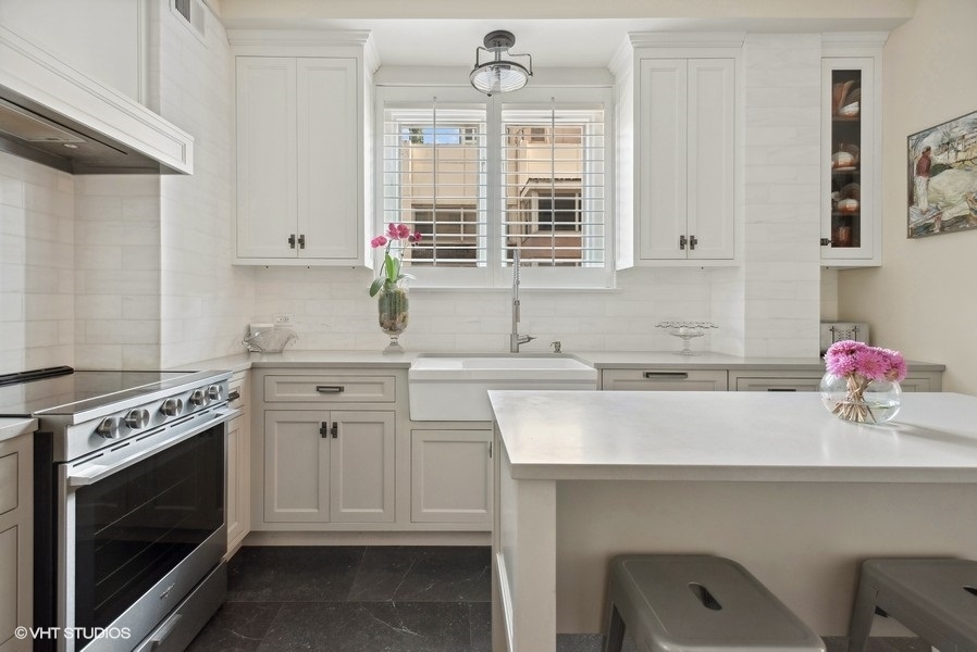 222 East Chestnut Street, Unit 17B Chicago, IL 60611 - Photo 12 of 29 a kitchen with cabinets appliances and a sink