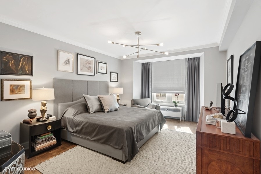 222 East Chestnut Street, Unit 17B Chicago, IL 60611 - Photo 16 of 29 a bedroom with a bed couch and a window