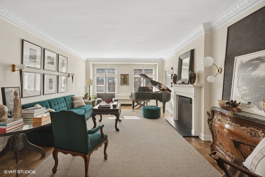 222 East Chestnut Street, Unit 17B Chicago, IL 60611 - Photo 2 of 29 a living room with furniture a fireplace and a flat screen tv