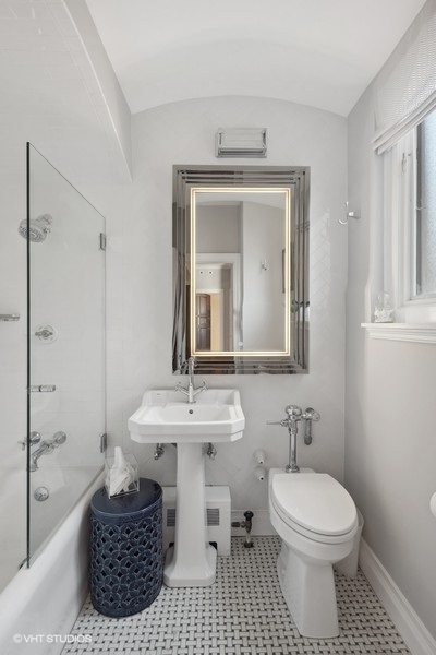 222 East Chestnut Street, Unit 17B Chicago, IL 60611 - Photo 23 of 29 a bathroom with a toilet a sink and a mirror