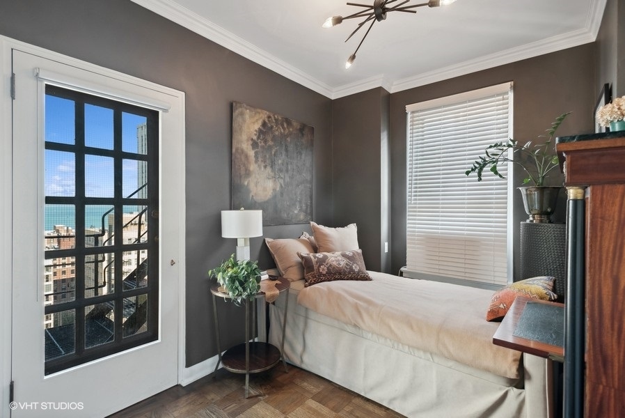 222 East Chestnut Street, Unit 17B Chicago, IL 60611 - Photo 25 of 29 a bedroom with a bed and a window