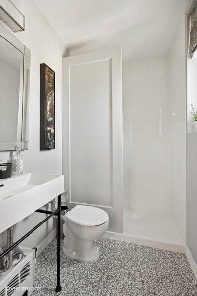 222 East Chestnut Street, Unit 17B Chicago, IL 60611 - Photo 27 of 29 a bathroom with a toilet a sink and mirror
