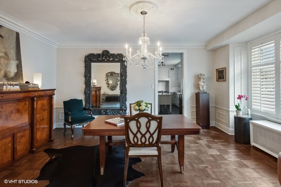 222 East Chestnut Street, Unit 17B Chicago, IL 60611 - Photo 9 of 29 a view of a dining room with furniture and chandelier