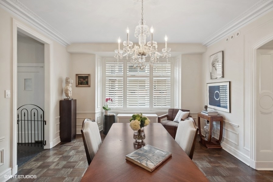 222 East Chestnut Street, Unit 17B Chicago, IL 60611 - Photo 10 of 29 a living room with furniture and a chandelier