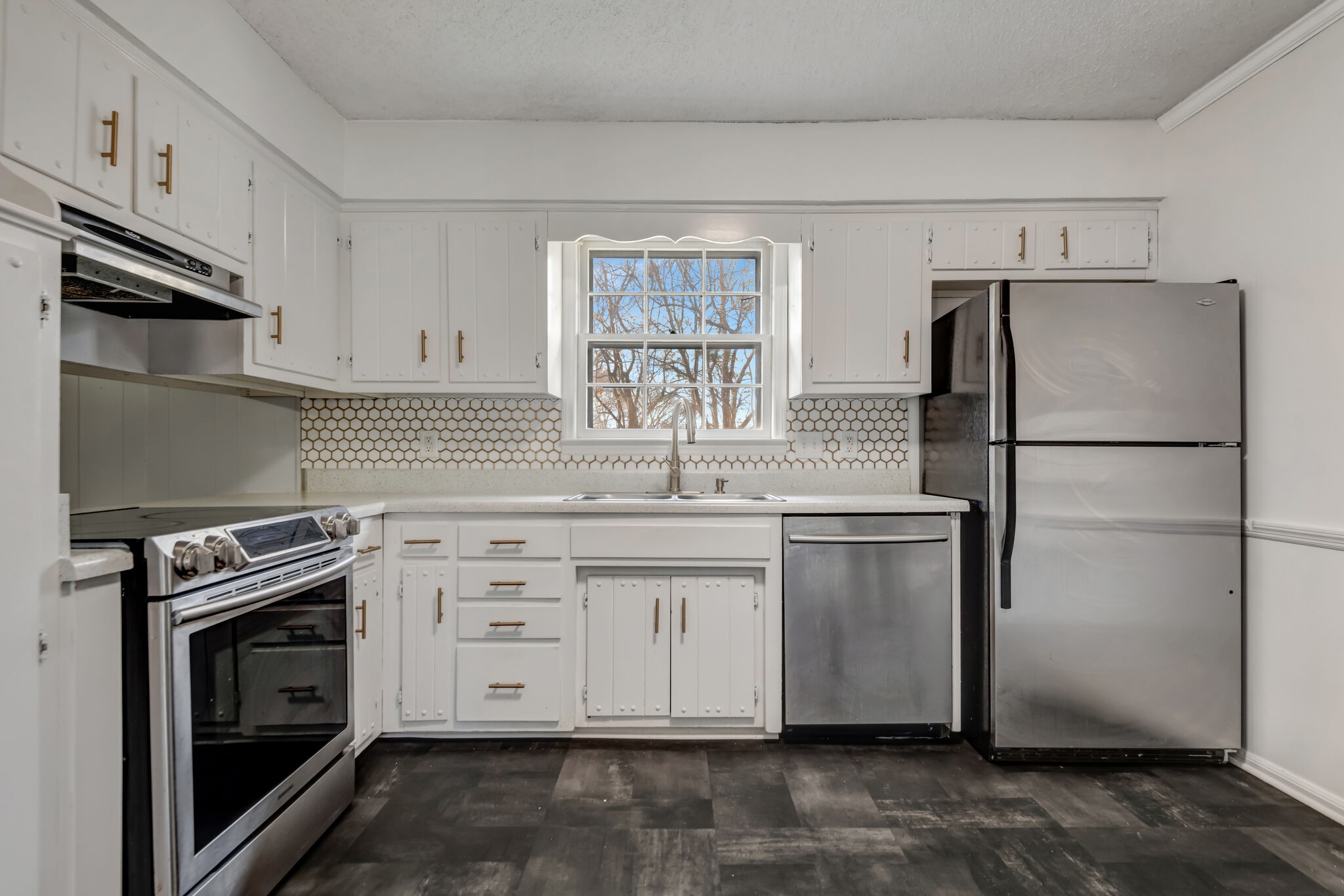 561 Castlegate Drive Nashville, TN 37217 - Photo 4 of 21 a kitchen with white cabinets and stainless steel appliances