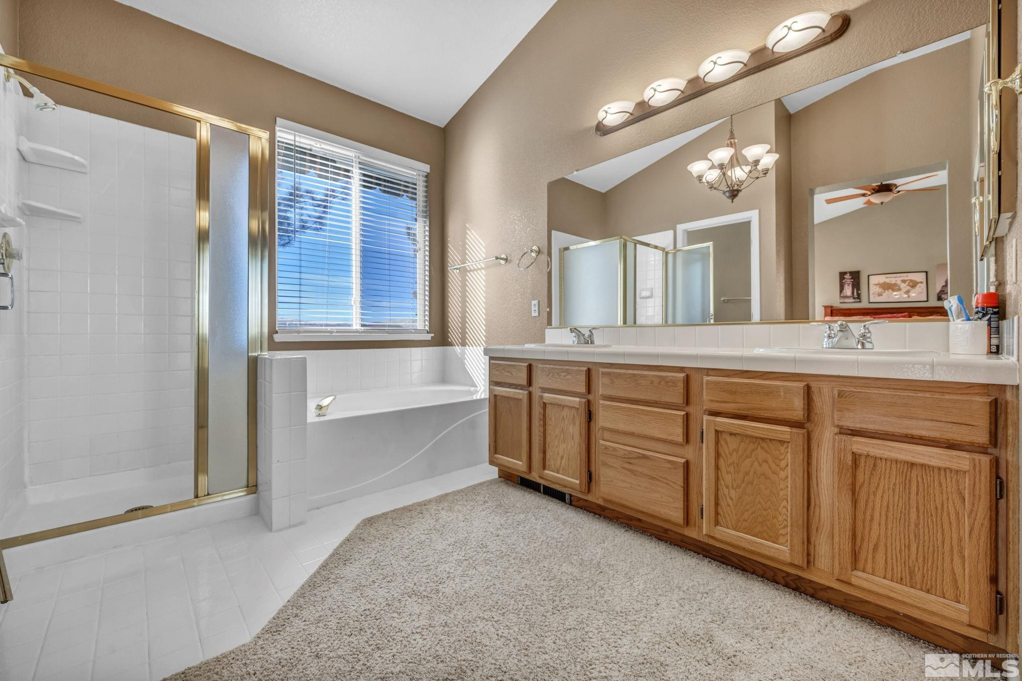 4805 Crestside Drive Sparks, NV 89436 - Photo 18 of 33 a spacious bathroom with a granite countertop sink mirror and a